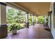 Inviting front porch with tile flooring, large white columns, and mature landscaping at 570 Park Se Ave, Atlanta, GA 30312