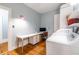 Bright laundry room includes an integrated workspace with desk and lots of storage with washer and dryer at 570 Park Se Ave, Atlanta, GA 30312