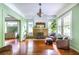 Bright living room featuring hardwood floors, a decorative fireplace, large windows, and stylish chairs with ottoman at 570 Park Se Ave, Atlanta, GA 30312