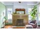 Living room featuring a brick fireplace, decorative mirror and trim, and natural light at 570 Park Se Ave, Atlanta, GA 30312