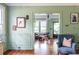 Open living room with hardwood floors, soft green walls, and an open doorway at 570 Park Se Ave, Atlanta, GA 30312
