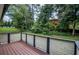 View of the stained, wood back deck with horizontal plank railings overlooking the backyard of the house at 905 Hickory Ridge Sw Rd, Lilburn, GA 30047