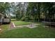 The backyard has a built-in trampoline and a lush green lawn at 905 Hickory Ridge Sw Rd, Lilburn, GA 30047