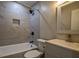 Bathroom with a shower and bathtub featuring marble tile and modern fixtures at 905 Hickory Ridge Sw Rd, Lilburn, GA 30047