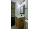 Vanity features natural wood, with a vessel sink, a black faucet, and modern lighting at 905 Hickory Ridge Sw Rd, Lilburn, GA 30047