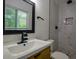 This bathroom is equipped with modern fixtures and a stylish wooden vanity at 905 Hickory Ridge Sw Rd, Lilburn, GA 30047