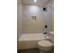 Bright bathroom features a marble tiled shower and a white bathtub at 905 Hickory Ridge Sw Rd, Lilburn, GA 30047