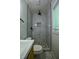 This bathroom has a modern shower stall with white marble tiling and decorative pebbles at 905 Hickory Ridge Sw Rd, Lilburn, GA 30047