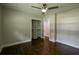 Spacious bedroom with hardwood floors, a ceiling fan, and a large closet at 905 Hickory Ridge Sw Rd, Lilburn, GA 30047