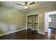 Bedroom featuring a ceiling fan, hardwood floors, and closet with shelves at 905 Hickory Ridge Sw Rd, Lilburn, GA 30047