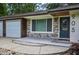 Close up of front door, facade, garage door, and landscaping at 905 Hickory Ridge Sw Rd, Lilburn, GA 30047