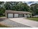 Well-maintained single-Gathering home with a long driveway leading to a two-car garage and landscaped front yard at 905 Hickory Ridge Sw Rd, Lilburn, GA 30047