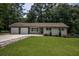 Ranch style home with a brick and wood facade and a green lawn at 905 Hickory Ridge Sw Rd, Lilburn, GA 30047