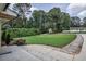 Charming home with a well manicured front lawn, lush landscaping, and a long driveway at 905 Hickory Ridge Sw Rd, Lilburn, GA 30047