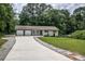 Charming ranch-style home with a long driveway and well-manicured lawn at 905 Hickory Ridge Sw Rd, Lilburn, GA 30047