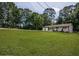 Ranch style home with large front yard and mature trees at 905 Hickory Ridge Sw Rd, Lilburn, GA 30047