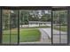 View of the home through the window, showcasing the well manicured lawn and beautiful landscaping at 905 Hickory Ridge Sw Rd, Lilburn, GA 30047