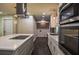 Modern kitchen featuring stainless appliances, sleek countertops, and an island with cooktop at 905 Hickory Ridge Sw Rd, Lilburn, GA 30047