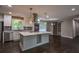 Open kitchen layout with a large island, stainless steel appliances, and hardwood flooring at 905 Hickory Ridge Sw Rd, Lilburn, GA 30047