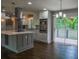 Modern kitchen featuring stainless steel appliances, a large island with a wine rack, and hardwood floors at 905 Hickory Ridge Sw Rd, Lilburn, GA 30047