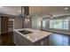 Well-lit kitchen featuring an island with induction cooktop and views to the front yard at 905 Hickory Ridge Sw Rd, Lilburn, GA 30047