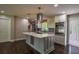 Updated kitchen boasting stainless appliances, island with wine rack, and hardwood floors at 905 Hickory Ridge Sw Rd, Lilburn, GA 30047