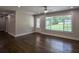 Bright living room featuring hardwood floors and a large window with natural light at 905 Hickory Ridge Sw Rd, Lilburn, GA 30047