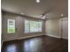 Bright living room with hardwood floors, neutral walls, and a modern ceiling fan at 905 Hickory Ridge Sw Rd, Lilburn, GA 30047