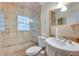 Bathroom featuring tiled walls, glass enclosed shower, toilet and single sink vanity at 2232 Dunseath Nw Ave # 309, Atlanta, GA 30318