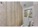 Bathroom features stone mosaic wall tiles, toilet, and large mirror at 2232 Dunseath Nw Ave # 309, Atlanta, GA 30318