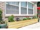 Exterior view of a brick home with decorative planter box and colorful flowers at 2232 Dunseath Nw Ave # 309, Atlanta, GA 30318