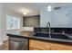 Kitchen with dark countertops, updated stainless steel dishwasher, and stainless steel faucet at 2232 Dunseath Nw Ave # 309, Atlanta, GA 30318