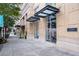 Exterior of building featuring awnings and landscaped sidewalk at 285 Centennial Olympic Park Nw Dr # 1407, Atlanta, GA 30313