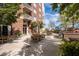 Condo patio with brick and wood furniture on concrete with an outdoor cooking area with a lush green tree backdrop at 285 Centennial Olympic Park Nw Dr # 1407, Atlanta, GA 30313