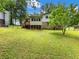 Large green backyard with a full back view of the house, back deck and stairs at 784 San Miguel Dr, Stone Mountain, GA 30083