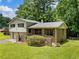 Two-story home with a well-kept lawn and brick wall in a lush, green setting at 784 San Miguel Dr, Stone Mountain, GA 30083