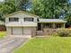 Charming home with a two-car garage and well-maintained lawn and brickwork at 784 San Miguel Dr, Stone Mountain, GA 30083
