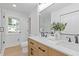 Bright bathroom with a double sink vanity, modern fixtures, large mirror, and a view to the backyard at 3008 Ridgeside Ct, Atlanta, GA 30341