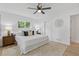 Comfortable bedroom featuring a plush bed, stylish lamps, and a large window overlooking lush greenery at 3008 Ridgeside Ct, Atlanta, GA 30341