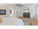 Well-lit bedroom with a ceiling fan, dresser and an entryway to another room at 3008 Ridgeside Ct, Atlanta, GA 30341