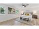 Light bedroom with a ceiling fan, decor art, area rug, and two windows at 3008 Ridgeside Ct, Atlanta, GA 30341