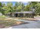 Charming home with a stone facade, large windows, mature trees, and a well-manicured lawn at 3008 Ridgeside Ct, Atlanta, GA 30341