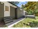 Side exterior view of the home with a brick facade, steps, and patio area at 3008 Ridgeside Ct, Atlanta, GA 30341