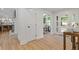 Foyer with light wood floors, white trim, doors, access to the kitchen, and view into the living room at 3008 Ridgeside Ct, Atlanta, GA 30341