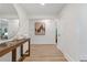 Contemporary foyer with wood floors, console table, decor, and white walls leading to other rooms at 3008 Ridgeside Ct, Atlanta, GA 30341