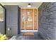 Modern front door with glass panels, set against a stone and brick exterior with matte black accents at 3008 Ridgeside Ct, Atlanta, GA 30341