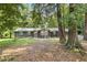 Charming home nestled among mature trees, featuring a stone facade and well-manicured lawn at 3008 Ridgeside Ct, Atlanta, GA 30341