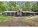 Charming home featuring a stone facade, large windows, mature trees, and a well-manicured lawn at 3008 Ridgeside Ct, Atlanta, GA 30341