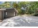 Spacious garage with an extended driveway and access to the backyard, surrounded by mature trees at 3008 Ridgeside Ct, Atlanta, GA 30341