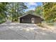 Spacious garage with an extended driveway and access to the backyard, surrounded by mature trees at 3008 Ridgeside Ct, Atlanta, GA 30341